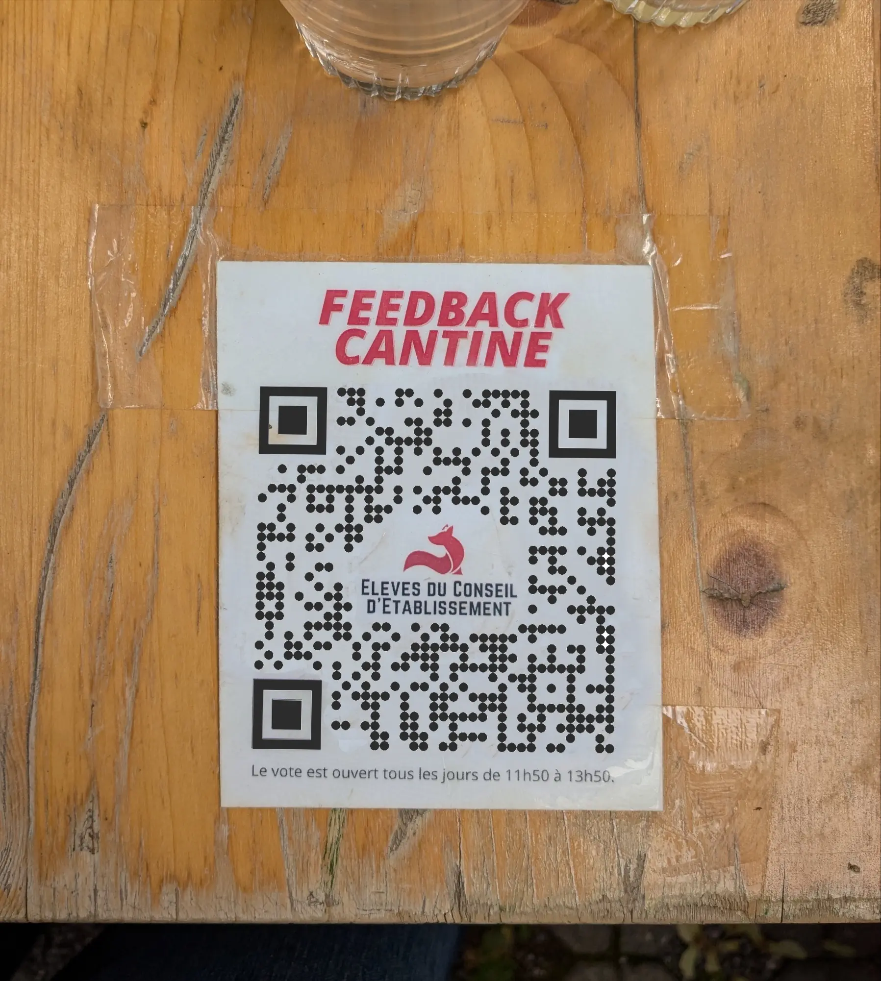 Sticker asking for ratings from the students with a QR code linking to the site.